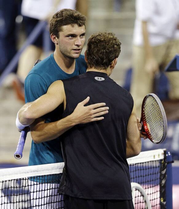 Gilles Simon, of France, is congratulated by Michael Russell, right, following a match at the U.S. Open tennis tournament.