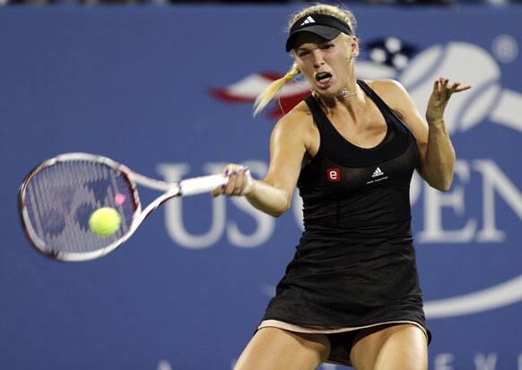 Caroline Wozniacki, of Denmark, returns to Irina-Camelia Begu, of Romania, in the first round of play at the U.S. Open tennis tournament.