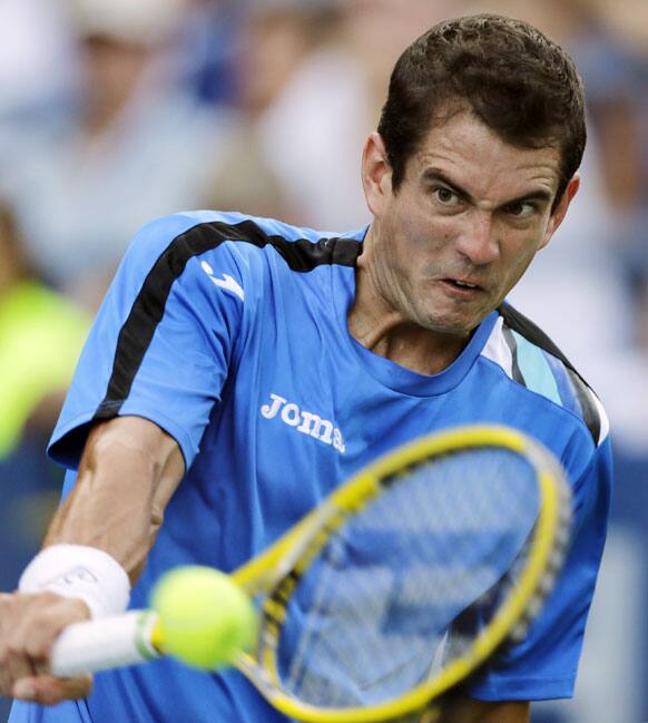 Guillermo Garcia-Lopez, of Spain, returns to Juan Monaco, of Argentina, in the first round of play at the U.S. Open tennis tournament.