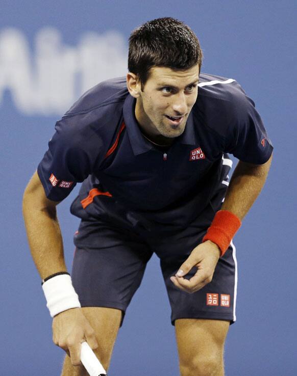 Novak Djokovic, of Serbia, eyes a return shot to Paolo Lorenzi, of Italy, during a match at the U.S. Open tennis tournament.