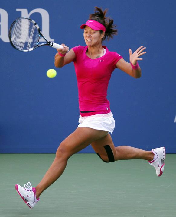 Li Na of China reaches for the ball during her match against Casey Dellacqua of Australia in the second round of play at the 2012 US Open tennis tournament.