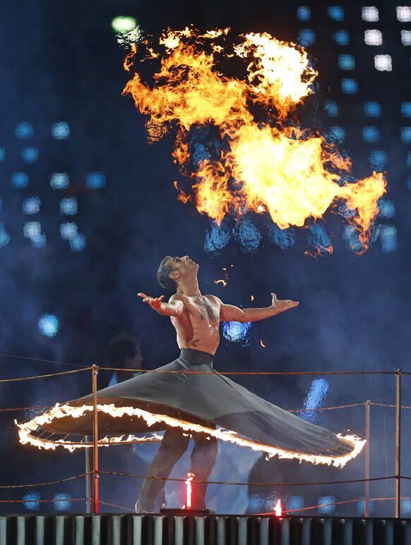 A member of the cast performs with fire during the Opening Ceremony for the 2012 Paralympics in London.