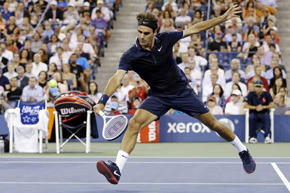 Roger Federer, of Switzerland, returns a shot Bjorn Phau, of Germany, during a match at the U.S. Open tennis tournament.