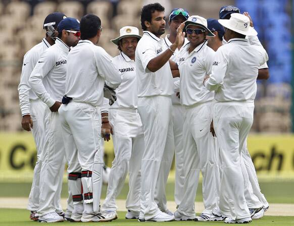 Zaheer Khan celebrates with teammates the dismissal of New Zealand batsman Brendon McCullum, during the first day of their second cricket test match in Bangalore.