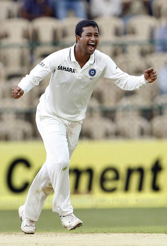 Pragyan Ojha celebrates the dismissal of New Zealand batsman Martin Guptill during the first day of their second cricket test match in Bangalore.