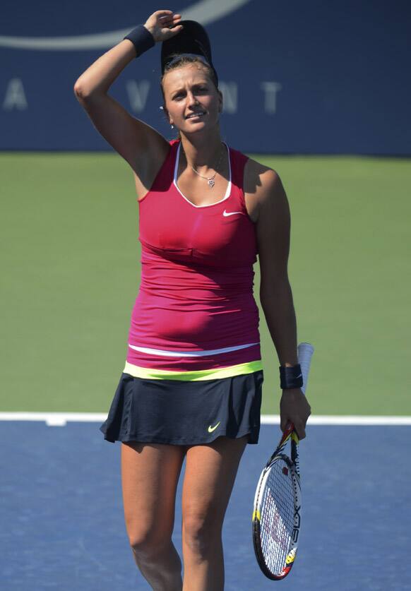 Petra Kvitova, of the Czech Republic, adjusts her cap during her match against Pauline Parmentier, of France, in the third round of play at the 2012 US Open tennis tournament, in New York. 