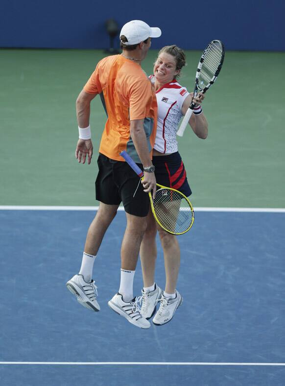 Belgium's Kim Clijsters, and Bob Bryan celebrate after their mixed doubles match against Irina Falconi and Steve Johnson in the third round of play at the 2012 US Open tennis tournament, in New York. 