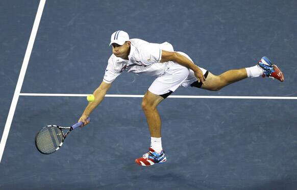 Andy Roddick returns a shot to Australia's Bernard Tomic in the third round of play at the 2012 US Open tennis tournament, in New York.