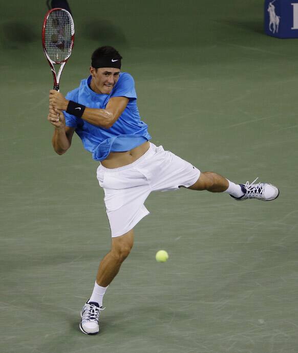 Australia's Bernard Tomic returns a shot to Andy Roddick in the third round of play at the 2012 US Open tennis tournament, in New York.