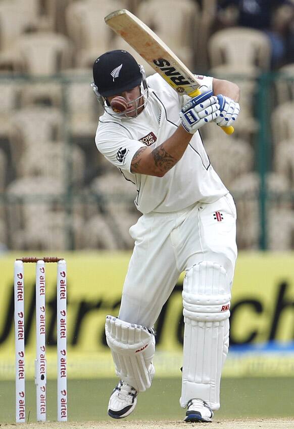 New Zealand batsman Doug Bracewell attempts to play a rising delivery by India's Umesh Yadav, not seen, during the second day of their second cricket test match in Bangalore.