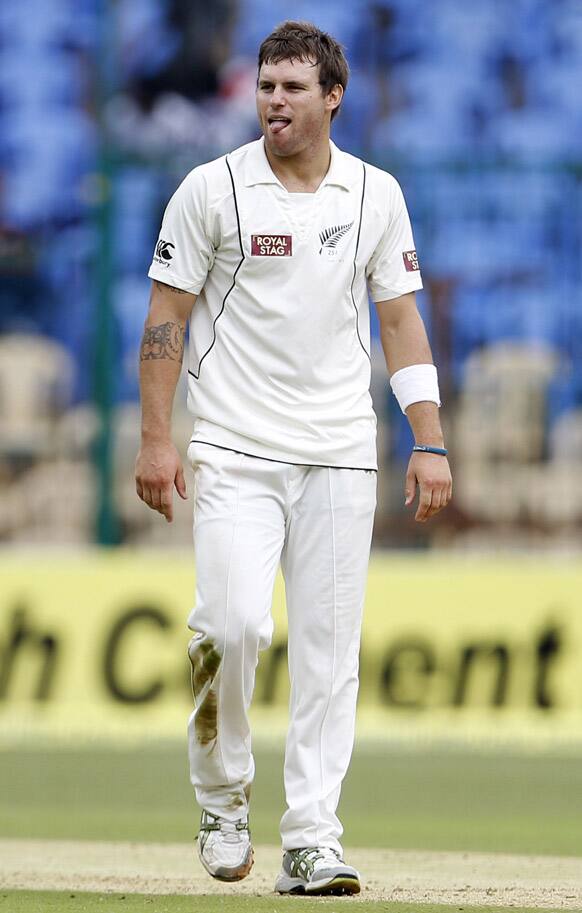 New Zealand bowler Doug Bracewell reacts after India's batsman Virender Sehwag, not seen, hit a boundary on his delivery during the second day of their second cricket test match in Bangalore