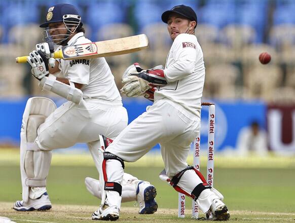 Sachin Tendulkar plays a shot as New Zealand wicketkeeper Kruger van Wyk reacts during the second day of their second cricket test match in Bangalore.