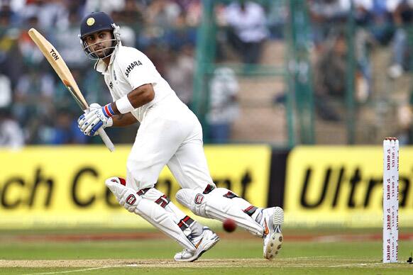 Virat Kohli watches his shot during the second day of the second cricket test match against New Zealand in Bangalore.