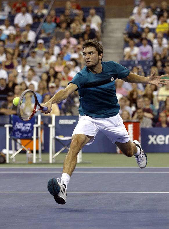 Gilles Simon, of France, returns a shot to Mardy Fish during a match at the US Open tennis tournament.