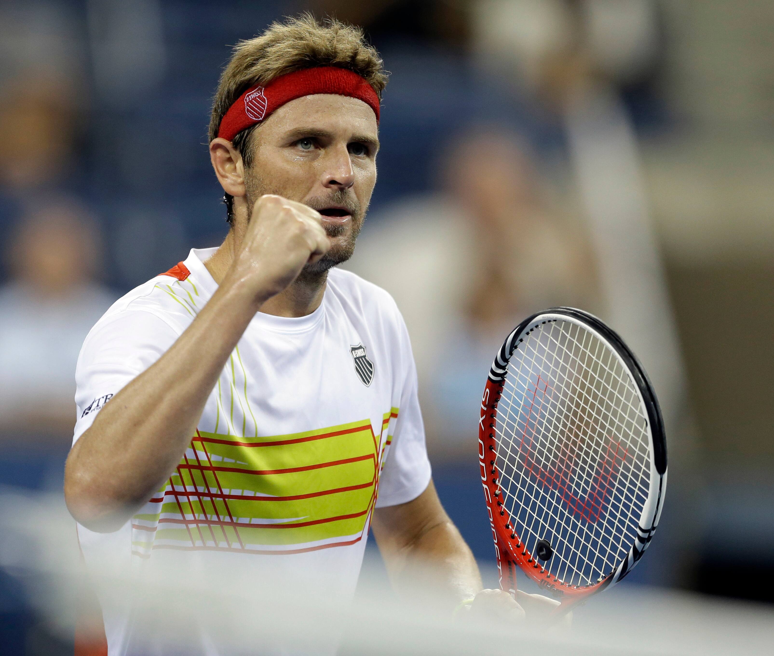 Mardy Fish reacts after breaking the serve of Gilles Simon, of France, during a match at the US Open tennis tournament .