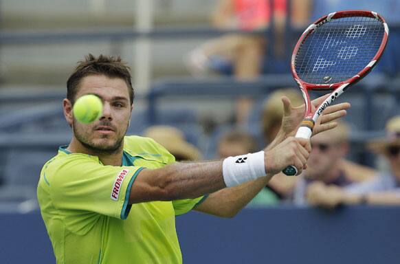 Switzerland's Stanislas Wawrinka returns a shot to Ukraine's Alexandr Dolgopolov in the third round of play at the 2012 US Open tennis tournament.