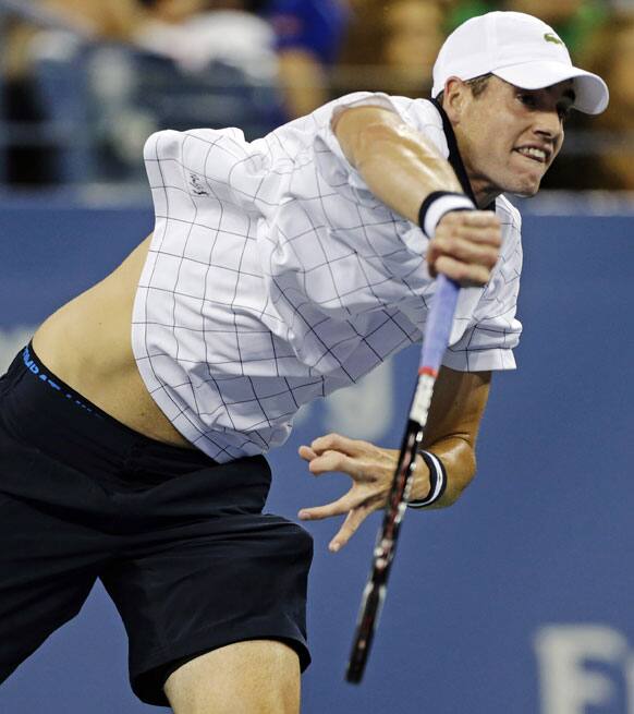 John Isner serves to Philipp Kohlschreiber, of Germany, in the third round of play at the US Open tennis tournament.