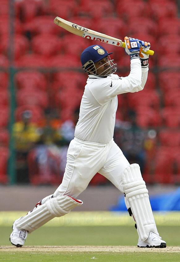 Virender Sehwag watches his shot during the fourth day of their second cricket test match against New Zealand in Bangalore.