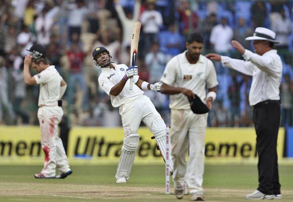 Virat Kohli, second left, celebrates their win over New Zealand on the fourth day of their second cricket test match in Bangalore.