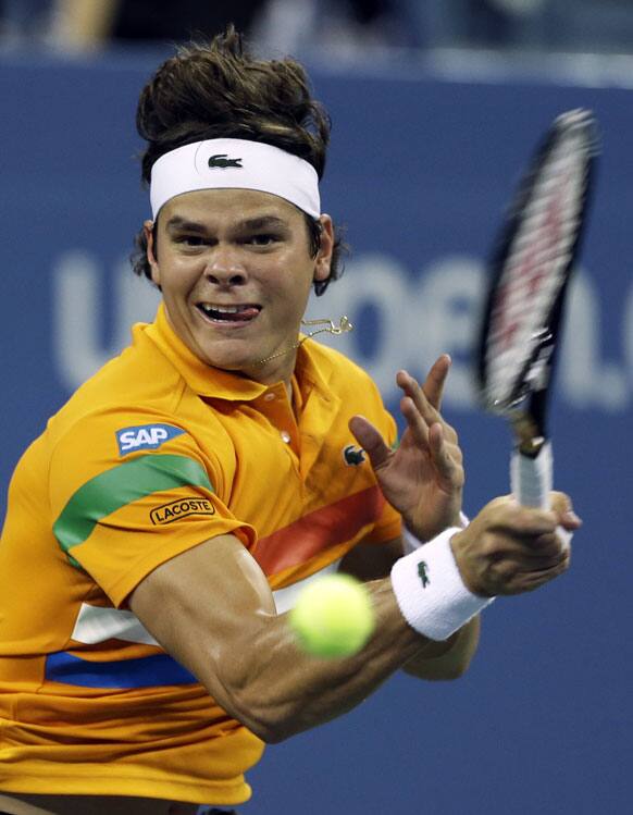 Milos Raonic, of Canada, returns a shot to Andy Murray, of Britain, during a match at the US Open tennis tournament.