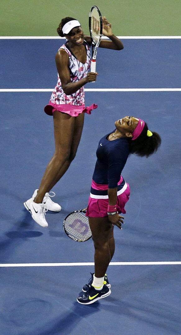 Venus Williams, left, and Serena Williams react as they miss a point during a match against Russia's Maria Kirilenko and Nadia Petrova in the third round of women's doubles play at the US Open tennis tournament.