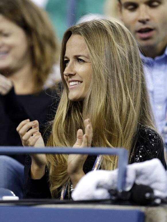 Kim Sears, the girlfriend of Andy Murray, of Britain, applauds as he is introduced before his match against Milos Raonic, of Canada, at the US Open tennis tournament.