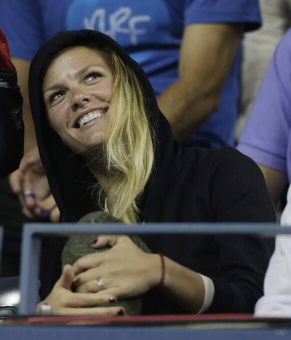 Brooklyn Decker smiles as Andy Roddick plays Argentina's Juan Martin Del Potro in the fourth round of play during the 2012 US Open tennis tournament in New York.