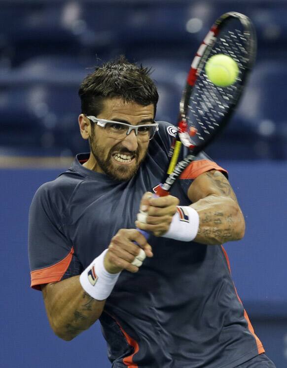 Serbia's Janko Tipsarevic returns a shot to Germany's Philipp Kohlschreiber in the fourth round of play at the 2012 US Open tennis tournament in New York. 