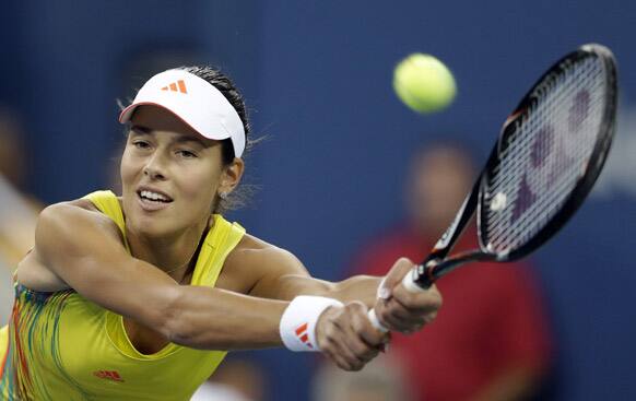 Ana Ivanovic, of Serbia, returns a shot to Serena Williams during a quarterfinals match at the U.S. Open tennis tournament.