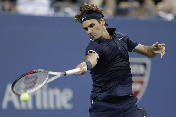 Roger Federer, of Switzerland, returns a shot to Tomas Berdych, of the Czech Republic, during a quarterfinal at the U.S. Open tennis tournament.