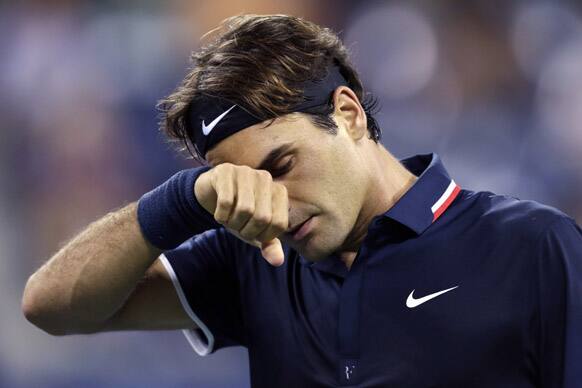 Roger Federer, of Switzerland, wipes his brow late in the fourth set during his loss to Tomas Berdych, of the Czech Republic, in the quarterfinal round of play at the U.S. Open tennis tournament in New York. Berdych won 7-6 (1), 6-4, 3-6, 6-3.