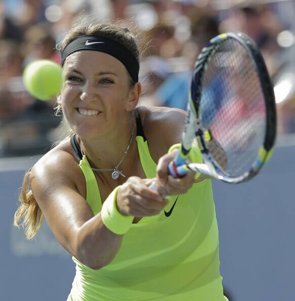 Victoria Azarenka, of Belarus, returns a shot to Maria Sharapova, of Russia, during a semifinal match at the 2012 US Open tennis tournament.