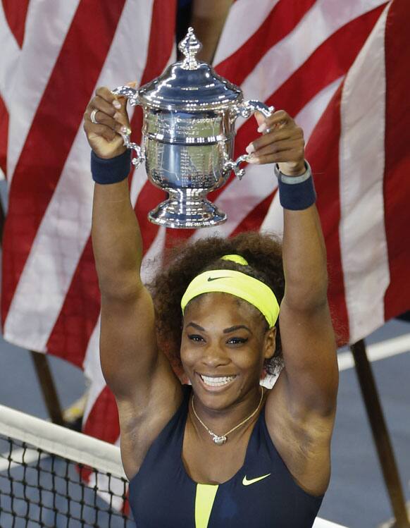 Serena Williams holds the championship trophy after beating Victoria Azarenka, of Belarus, in the championship match at the 2012 US Open tennis tournament.