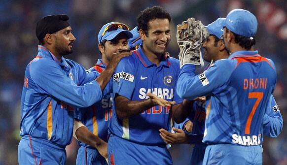 Indian cricketers congratulate teammate Irfan Pathan, center, for the dismissal of New Zealand's Martin Guptill during the second and final Twenty20 international cricket match between India and New Zealand in Chennai.