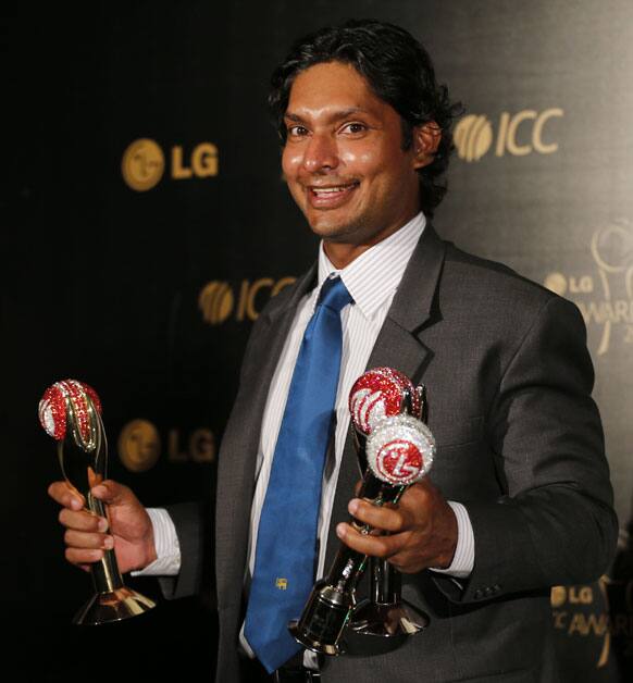 Sri Lankan cricketer Kumar Sangakkara poses with his Cricketer of the Year, Test Cricketer of the Year and People's Choice awards at the ICC Awards 2012 in Colombo.