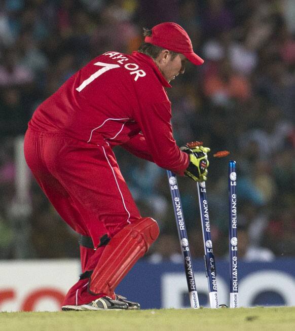 Zimbabwe's captain Brendan Taylor removes bails to dismiss Sri Lanka's Kumar Sangakkara, unseen, during the ICC Twenty20 Cricket World Cup match between Sri Lanka and Zimbabwe in Hambantota.