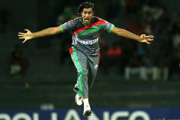 Afghanistan's bowler Shapoor Zadran, left, celebrates after taking the wicket of India's Gautam Gambhir, unseen, during their ICC Twenty20 Cricket World Cup match in Colombo, Sri Lanka.