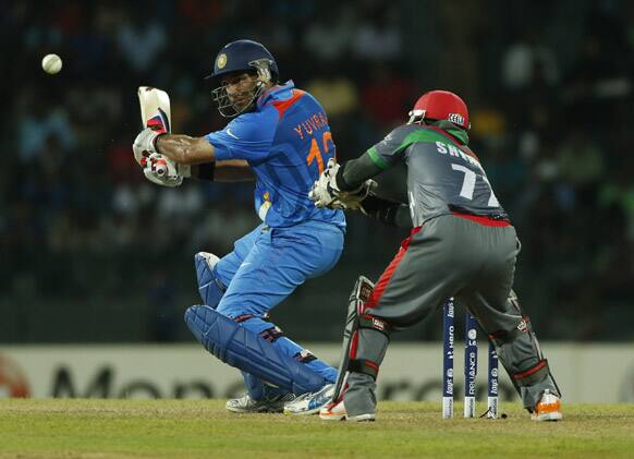 Yuvraj Singh plays a shot past Afghanistan's wicketkeeper Mohammad Shahzad during their ICC Twenty20 Cricket World Cup match in Colombo, Sri Lanka.