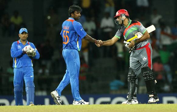 India's bowler Lakshmipathy Balaji, second left, shakes hands with Afghanistan's batsman Dawlat Zadran after defeating them by 23 runs in their ICC Twenty20 Cricket World Cup match in Colombo.