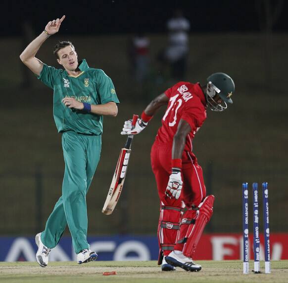 South Africa's bowler Morne Morkel, left celebrates the dismissal of Zimbabwe's batsman Vusi Sibanda, right during the ICC Twenty20 Cricket World Cup match between South Africa and Zimbabwe in Hambantota, Sri Lanka.