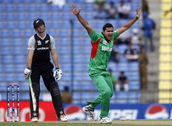 Bangladesh's bowler Mashrafe Mortaza, right, appeals unsuccessfully for the wicket of New Zealand batsman James Franklin, left, during the ICC Twenty20 Cricket World Cup match in Pallekele, Sri Lanka.