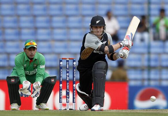 Bangladesh's captain Mushfiqur Rahim watches New Zealand batsman Brendon McCullum, bat during the ICC Twenty20 Cricket World Cup match in Pallekele, Sri Lanka.