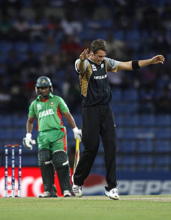 New Zealand bowler Tim Southee, right, celebrates after taking the wicket of Bangladesh's batsman Mohammad Ashraful, left, during the ICC Twenty20 Cricket World Cup match in Pallekele, Sri Lanka.