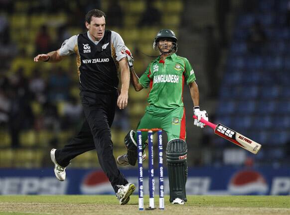 New Zealand bowler Kyle Mills, left, collides with Bangladesh's batsman Nasir Hossain during the ICC Twenty20 Cricket World Cup match in Pallekele, Sri Lanka.