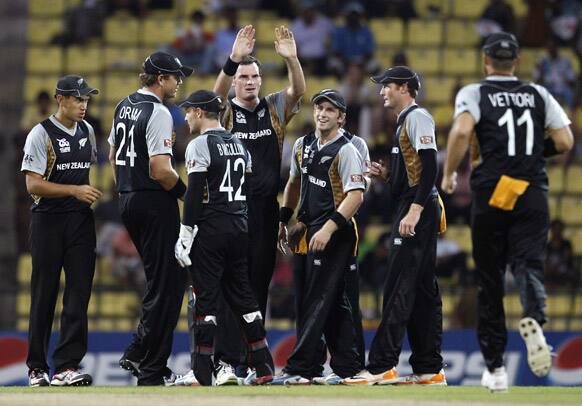 New Zealand bowler Kyle Mills, center without cap, raises his arms to celebrate taking the wicket of Bangladesh's batsman Shakib Al Hasan, not seen, during the ICC Twenty20 Cricket World Cup match in Pallekele, Sri Lanka.