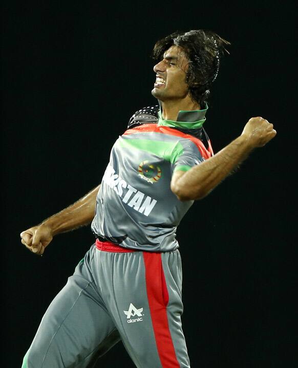 Afghanistan's bowler Shapoor Zadran celebrates taking the wicket of England's batsman Craig Kieswetter, unseen, during their match in the ICC Twenty20 Cricket World Cup in Colombo, Sri Lanka.