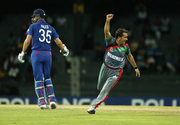 Afghanistan's bowler Karim Sadiq celebrates the dismissal of England's batsman Alex Hales, left, in the ICC Twenty20 Cricket World Cup in Colombo.