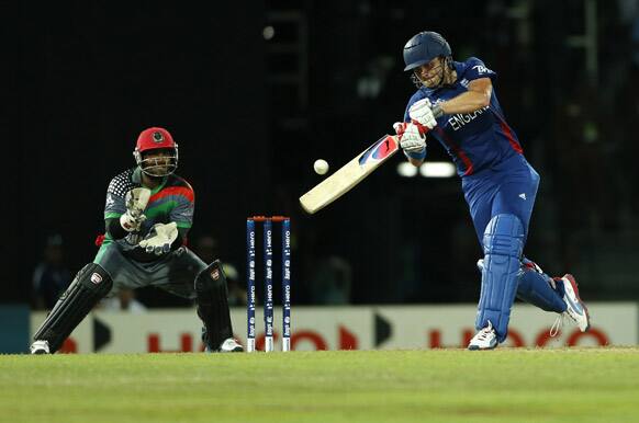 England's batsman Luke Wright, right, plays a shot as Afghanistan's wicket keeper Mohammad Shahzad watches during their ICC Twenty20 Cricket World Cup match in Colombo.