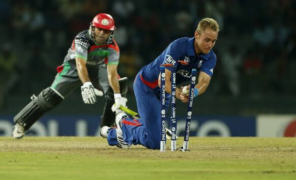 England's captain Stuart Broad successfully breaks the wicket to run out Afghanistan's batsman Karim Sadiq, left, during their ICC Twenty20 Cricket World Cup match in Colombo.