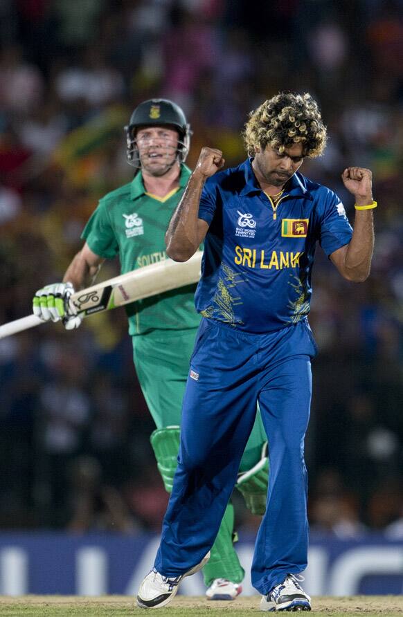 Sri Lanka's Lasith Malinga, right, celebrates the dismissal of South Africa's captain A.B. de Villiers, left, during their ICC Twenty20 Cricket World Cup match in Hambantota, Sri Lanka.